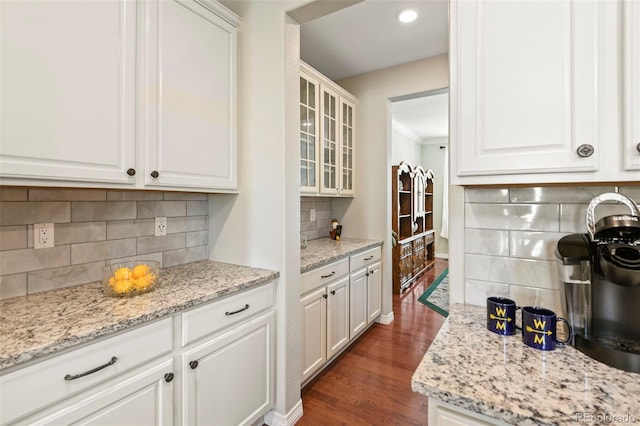 bar with baseboards, ornamental molding, recessed lighting, dark wood-type flooring, and backsplash