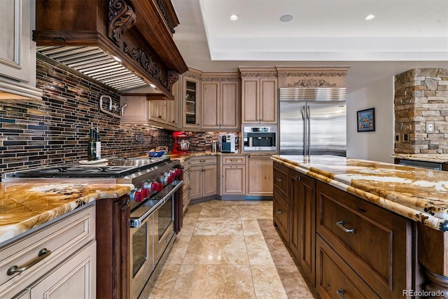kitchen featuring backsplash, high quality appliances, and custom range hood