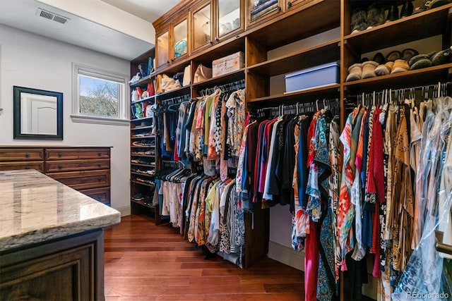 walk in closet with dark wood-type flooring and visible vents