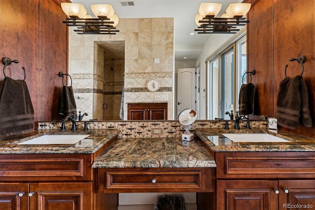 full bath featuring a chandelier, vanity, a stall shower, and visible vents