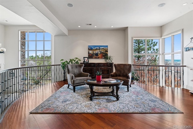 living area with visible vents, wood finished floors, and recessed lighting
