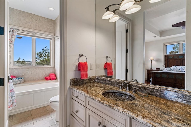 bathroom featuring a garden tub, toilet, tile patterned floors, vanity, and ensuite bath