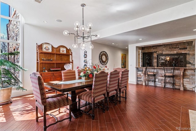 dining room with recessed lighting, wood finished floors, and a notable chandelier