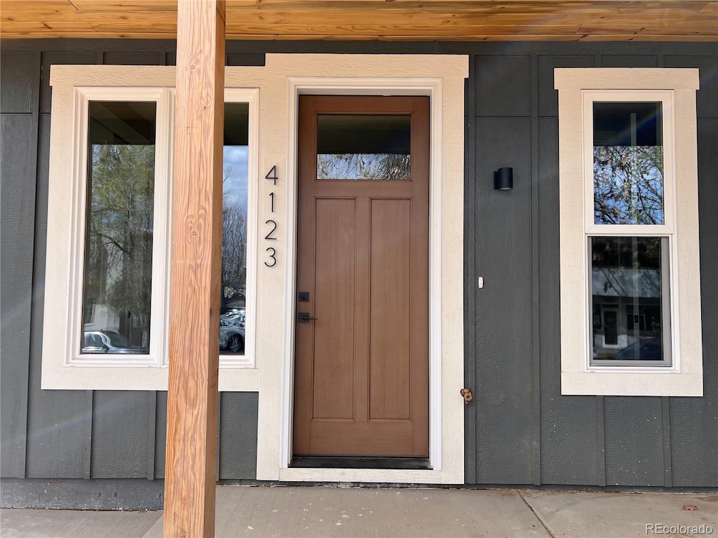 property entrance featuring board and batten siding