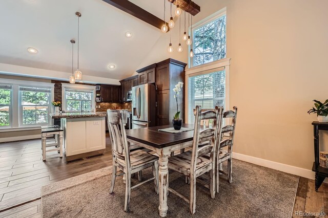 7445 Shoreham Pl, Castle Pines, CO 80108 - dining space featuring beamed ceiling, high vaulted ceiling, wood finished floors, and recessed lighting