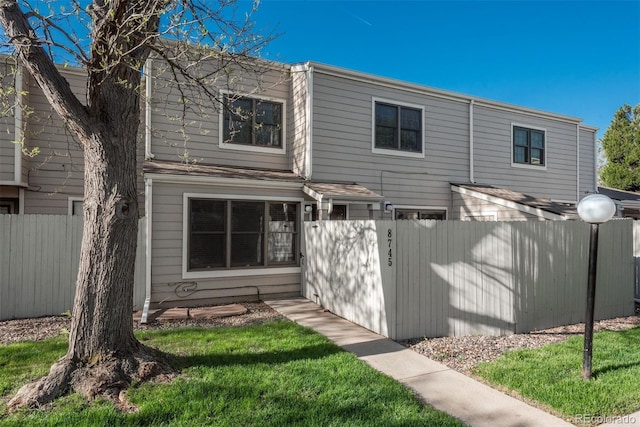 back of house with fence