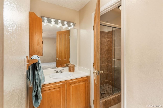 bathroom featuring a shower stall and vanity
