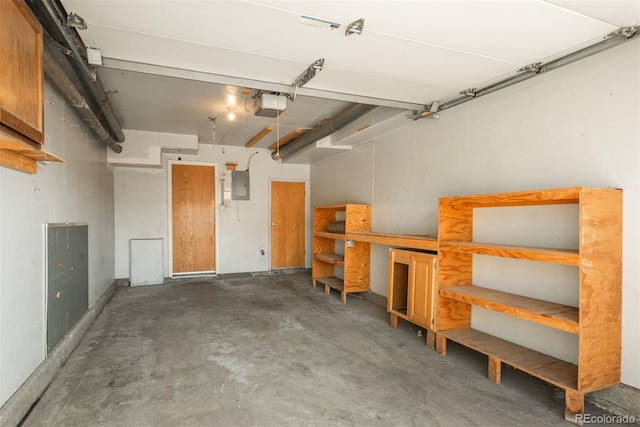 garage with electric panel and a garage door opener