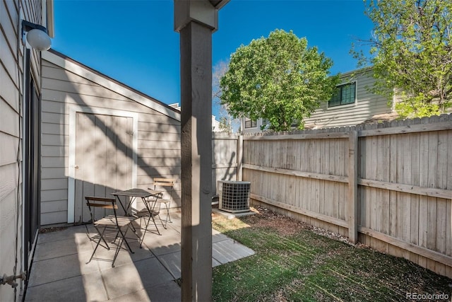 view of patio / terrace with fence and central AC unit