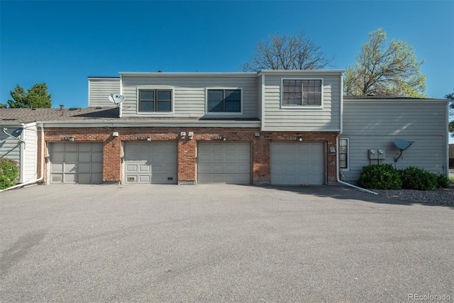 view of front of property with brick siding and a garage