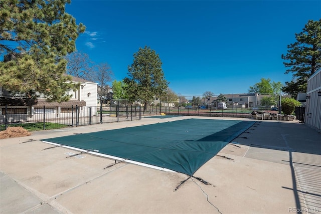view of pool featuring fence and a residential view