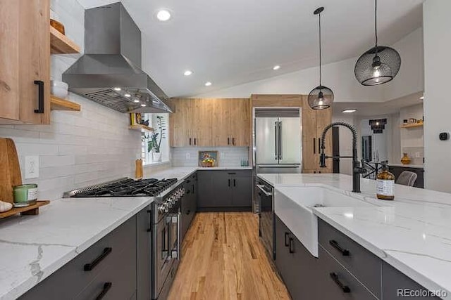 9561 Silver Hill Cir, Lone Tree, CO 80124 - kitchen with wall chimney exhaust hood, premium appliances, open shelves, vaulted ceiling, and hanging light fixtures