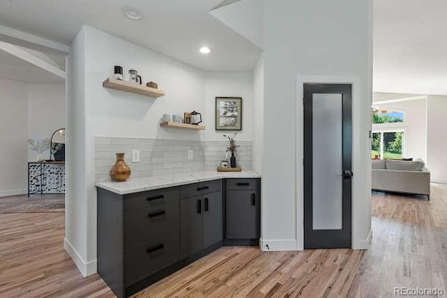 9561 Silver Hill Cir, Lone Tree, CO 80124 - bar area featuring light wood-type flooring, tasteful backsplash, and recessed lighting