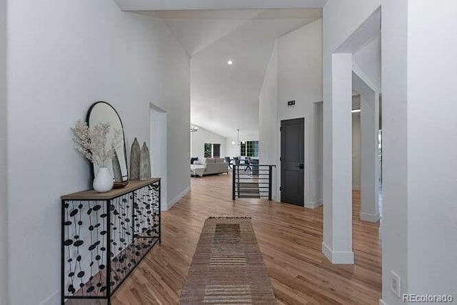 9561 Silver Hill Cir, Lone Tree, CO 80124 - hallway with lofted ceiling, wood finished floors, and an upstairs landing