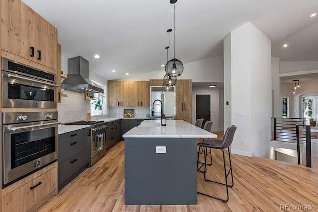 9561 Silver Hill Cir, Lone Tree, CO 80124 - kitchen featuring appliances with stainless steel finishes, wall chimney range hood, modern cabinets, lofted ceiling, and a kitchen island with sink