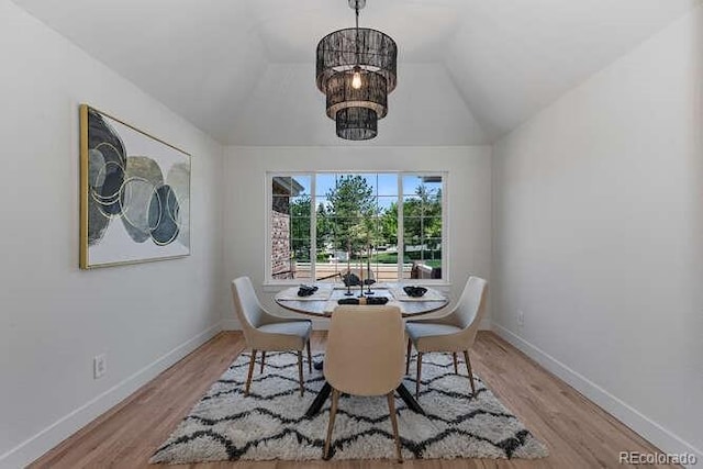 9561 Silver Hill Cir, Lone Tree, CO 80124 - dining space featuring wood finished floors, lofted ceiling, and a chandelier