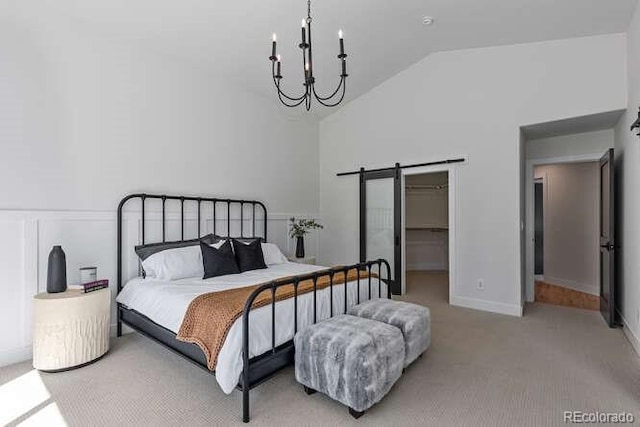 9561 Silver Hill Cir, Lone Tree, CO 80124 - carpeted bedroom featuring a barn door, a walk in closet, high vaulted ceiling, and a chandelier