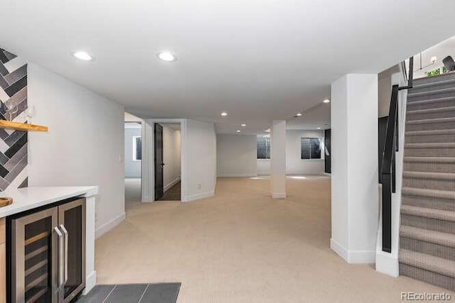 9561 Silver Hill Cir, Lone Tree, CO 80124 - finished below grade area featuring beverage cooler, light carpet, stairs, recessed lighting, and bar area