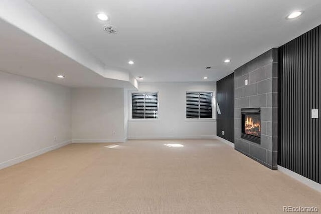 9561 Silver Hill Cir, Lone Tree, CO 80124 - unfurnished living room featuring light carpet, recessed lighting, and a tiled fireplace