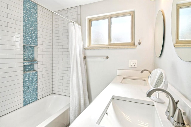 bathroom featuring vanity, a wealth of natural light, and shower / bath combo with shower curtain