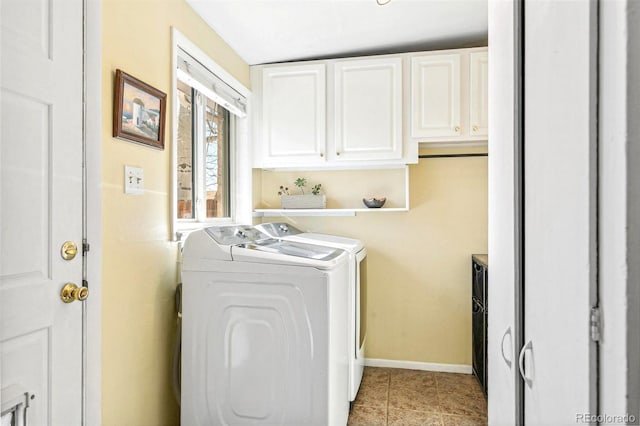 clothes washing area featuring light tile patterned flooring, cabinets, and separate washer and dryer