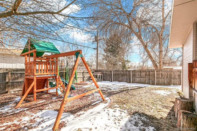 snowy yard with a playground