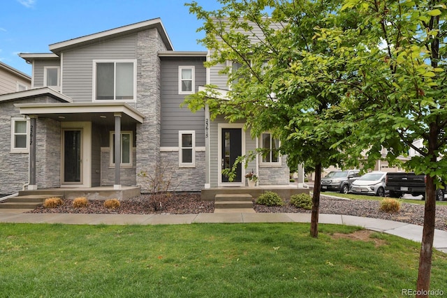 23615 E 5th Pl, Aurora, CO 80018 - view of front of home featuring stone siding and a front yard