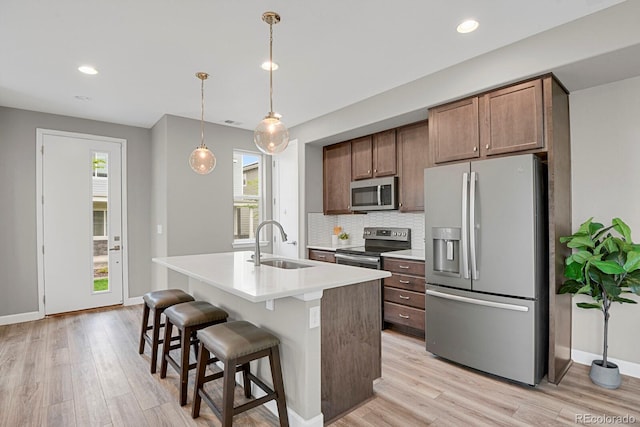 23615 E 5th Pl, Aurora, CO 80018 - kitchen with appliances with stainless steel finishes, a sink, healthy amount of natural light, backsplash, and recessed lighting
