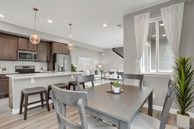 23615 E 5th Pl, Aurora, CO 80018 - dining room featuring light wood-type flooring, recessed lighting, and baseboards