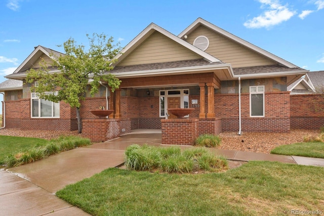 23615 E 5th Pl, Aurora, CO 80018 - view of front of property with brick siding, a front yard, and a shingled roof
