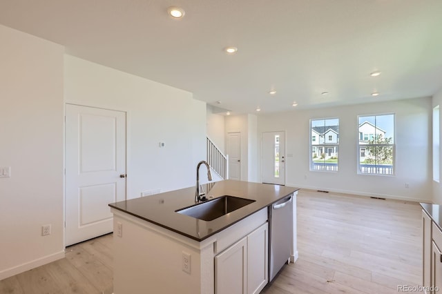 752 N Bently St, Watkins, CO 80137 - kitchen with dishwasher, light wood finished floors, dark countertops, recessed lighting, and a center island with sink