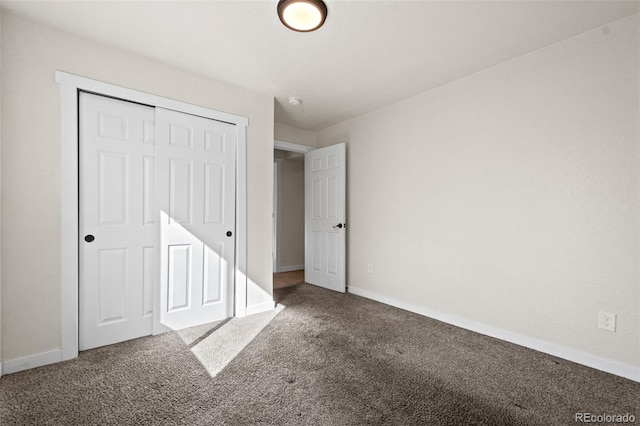 unfurnished bedroom with a closet and carpet flooring