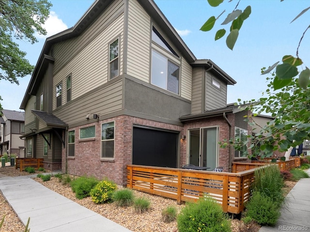 11719 W 45th Pl, Wheat Ridge, CO 80033 - view of side of property with a deck and brick siding