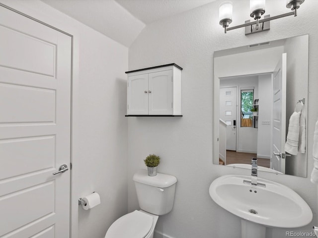 11719 W 45th Pl, Wheat Ridge, CO 80033 - half bathroom featuring toilet, a sink, and baseboards