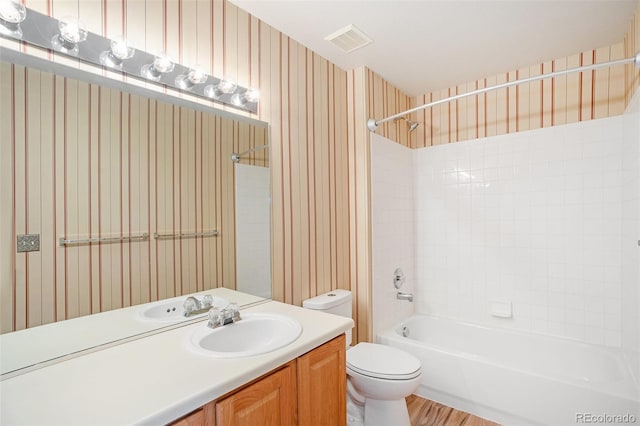 bathroom with visible vents, wallpapered walls, toilet, shower / bathtub combination, and vanity