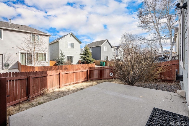 view of patio / terrace featuring a fenced backyard and a residential view