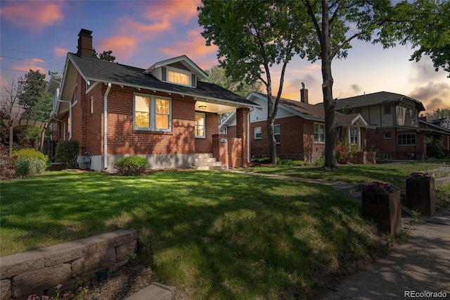 1260 S Emerson St, Denver, CO 80210 - view of front of house with brick siding, a chimney, and a lawn