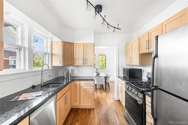 1260 S Emerson St, Denver, CO 80210 - kitchen featuring stainless steel appliances, a sink, hardwood / wood-style floors, and light brown cabinets