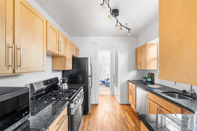 1260 S Emerson St, Denver, CO 80210 - kitchen featuring stainless steel appliances, a sink, light wood finished floors, light brown cabinetry, and dark stone countertops