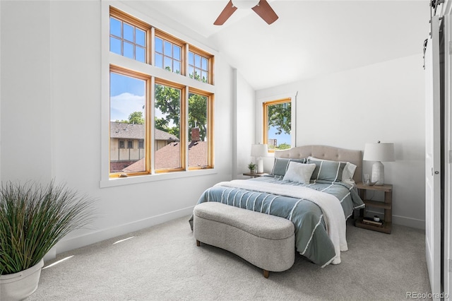 1260 S Emerson St, Denver, CO 80210 - bedroom with vaulted ceiling, carpet flooring, a barn door, baseboards, and ceiling fan