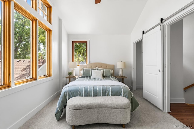 1260 S Emerson St, Denver, CO 80210 - bedroom featuring a barn door, baseboards, and vaulted ceiling