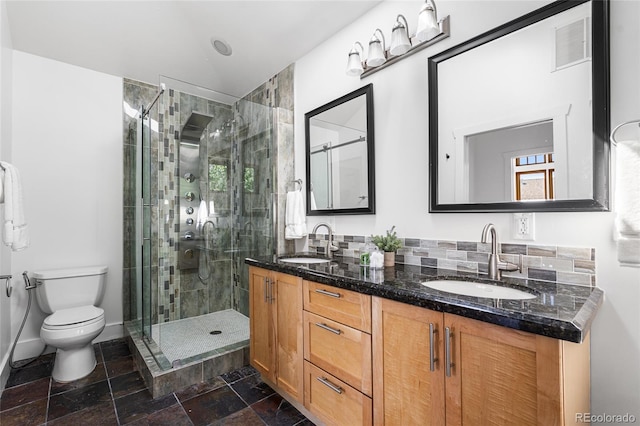 1260 S Emerson St, Denver, CO 80210 - full bath featuring a stall shower, toilet, double vanity, stone finish floors, and baseboards