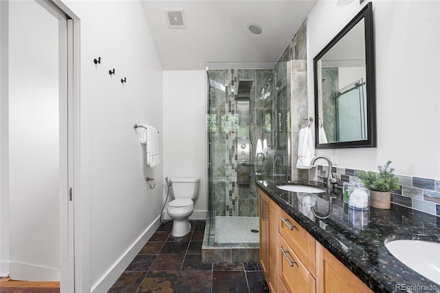 1260 S Emerson St, Denver, CO 80210 - full bath featuring double vanity, a shower stall, toilet, baseboards, and stone finish flooring