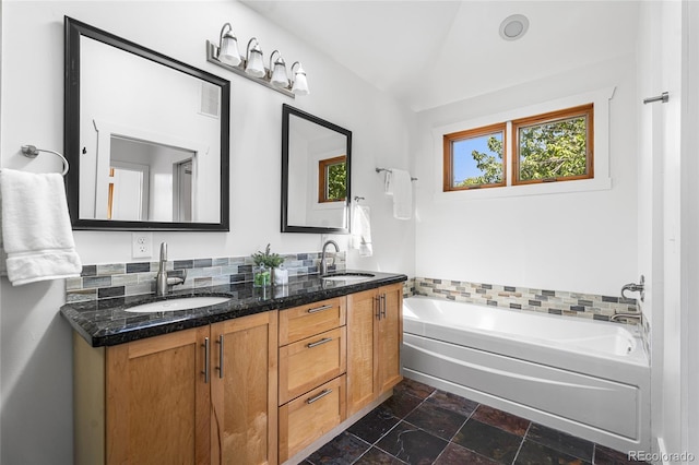 1260 S Emerson St, Denver, CO 80210 - full bathroom featuring double vanity, a bath, and stone tile floors