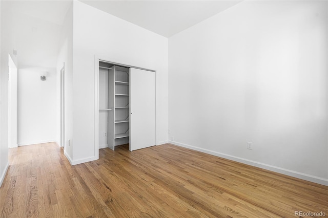 1260 S Emerson St, Denver, CO 80210 - unfurnished bedroom with wood finished floors, a closet, and baseboards