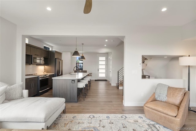 378 E Agate Unit 1B, Granby, CO 80446 - living area featuring light wood-type flooring, recessed lighting, stairs, and ceiling fan