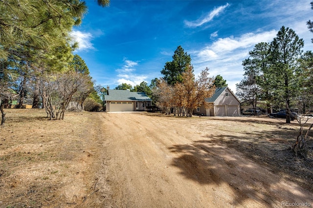 view of front of property featuring an outbuilding and dirt driveway