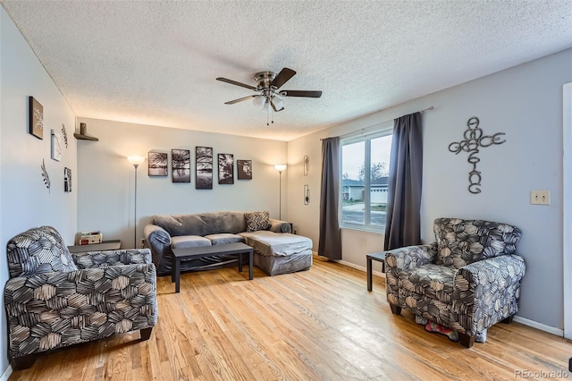 3512 E 117th Pl, Thornton, CO 80233 - living area featuring a ceiling fan, light wood-style flooring, a textured ceiling, and baseboards