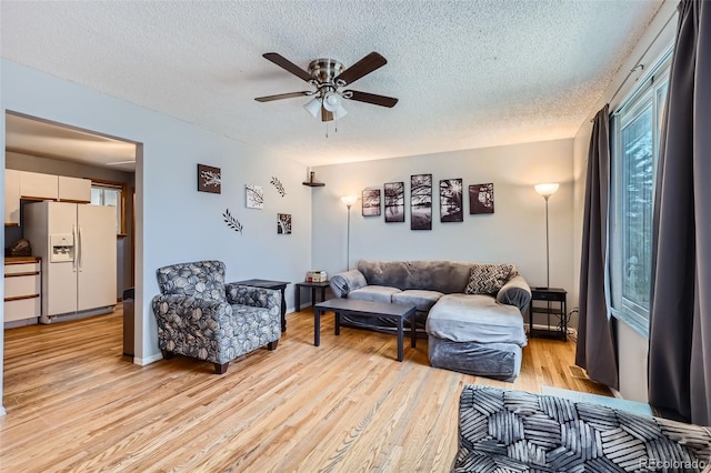 3512 E 117th Pl, Thornton, CO 80233 - living area with a textured ceiling, ceiling fan, and light wood finished floors