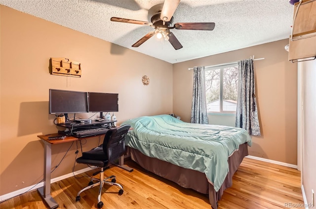 3512 E 117th Pl, Thornton, CO 80233 - bedroom featuring a textured ceiling, light wood-style floors, baseboards, a ceiling fan, and a desk